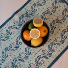 Load image into Gallery viewer, Fruit bowl with lemons and oranges on a block printed floral kitchen towel