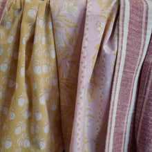 Load image into Gallery viewer, Close-up of kitchen towel with yellow floral pattern, pink floral pattern, and red striped pattern.