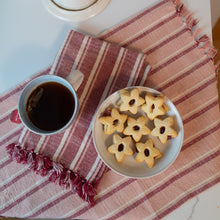 Load image into Gallery viewer, Striped burgundy and pink towel under tea and cookies. 