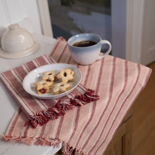 Load image into Gallery viewer, Folded striped burgundy and pink towels on the corner of a table. Towels have tasseled ends, and thick slubby yarn. 