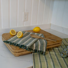 Load image into Gallery viewer, Image shows green and aqua kitchen towels contrasted against wood cutting board and lemons. 