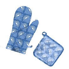 Load image into Gallery viewer, image showing contrast between oven mitt and potholder. Oven mitt features a blue base and light blue / white block printed sunrise / sunset image. Potholder has a light blue base color and a dark blue / white sunset / sunrise image. 